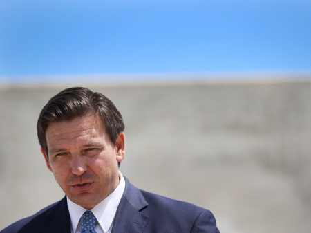 Florida Gov. Ron DeSantis speaks to the media about the cruise industry during a press conference at PortMiami in April. DeSantis faces criticism for failing to do all he could on Florida's biggest environmental threat: climate change.