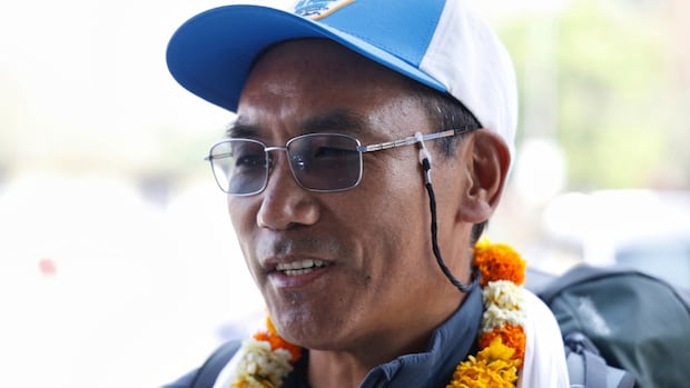 Sherpa guide breaks record by making 31st summit of Mount Everest