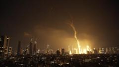 Explosions and huge plumes of smoke in Tel Aviv as Iran retaliates