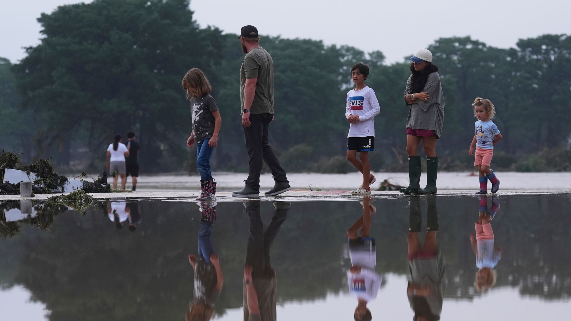 At least 24 dead and more than 20 children missing from camp in flooding