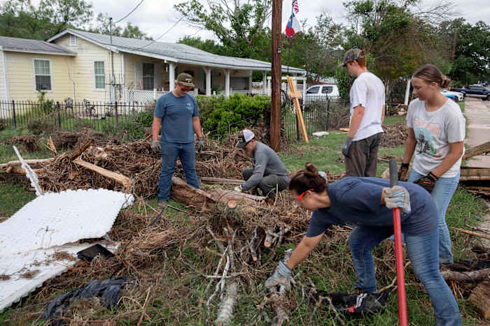 Armies of Texas volunteers dig out, clean up, after fatal floods