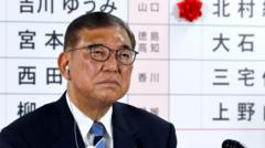 Japan’s PM vows to stay on despite bruising exit poll