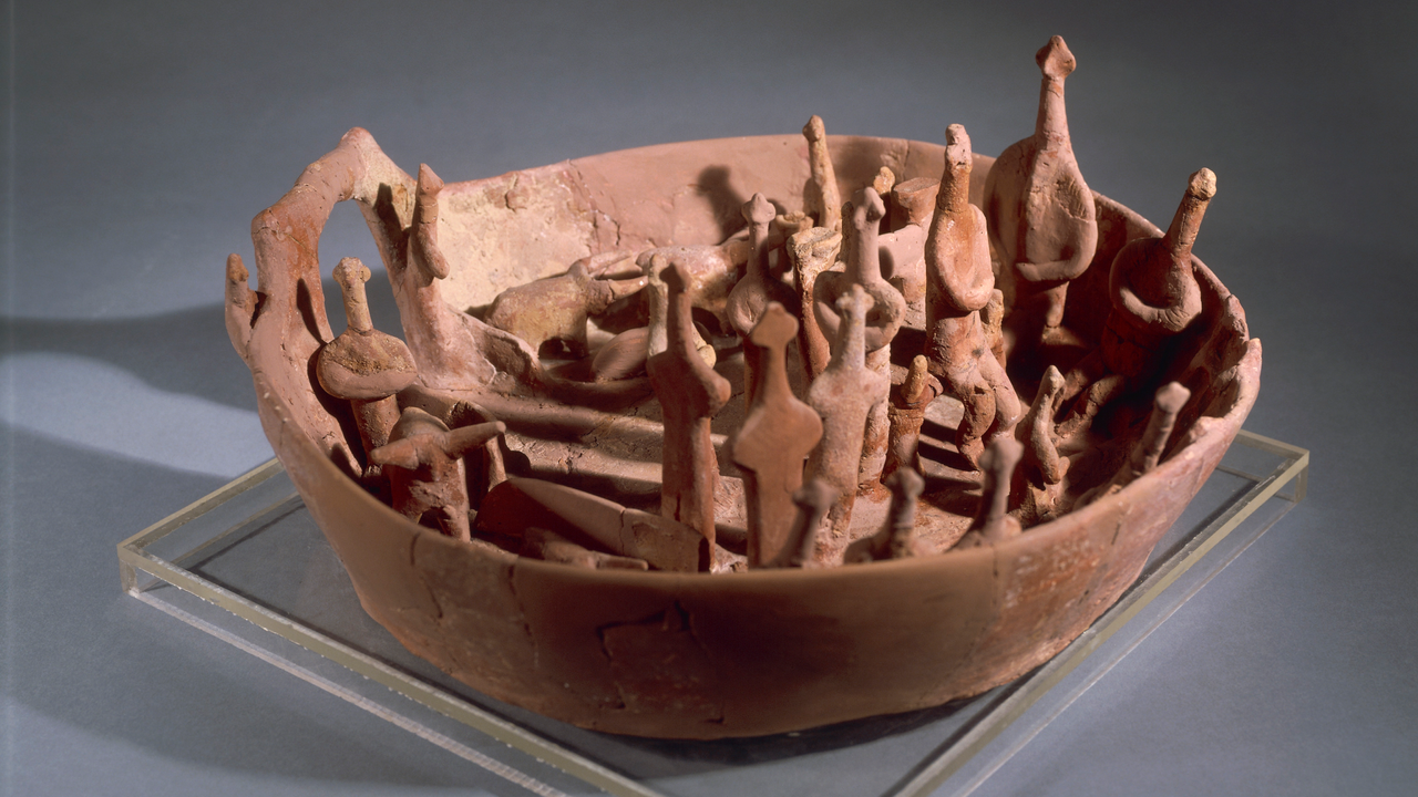 Vounous Bowl: A 4,000-year-old basin holding 4 miniature cows and 18 people — that was buried for mysterious reasons in a Bronze Age tomb in Cyprus