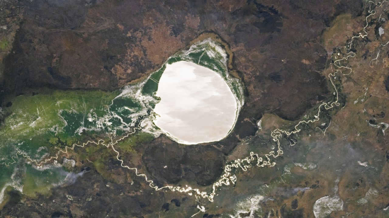 Lake-filled impact crater in Africa transforms into a giant silver ‘mirror’ via rare phenomenon — Earth from space
