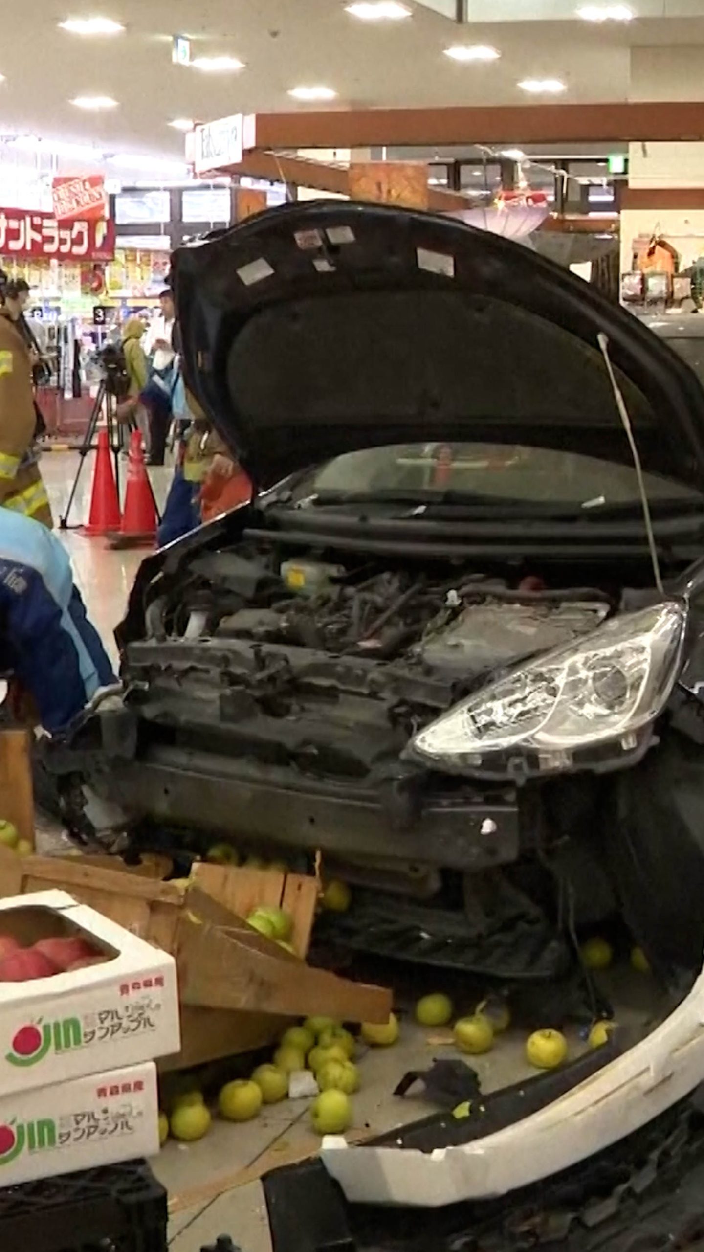 Car falls from rooftop parking lot into supermarket