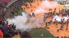 Kenya police fire shots and tear gas at crowds gathered to see body of ex-PM Odinga