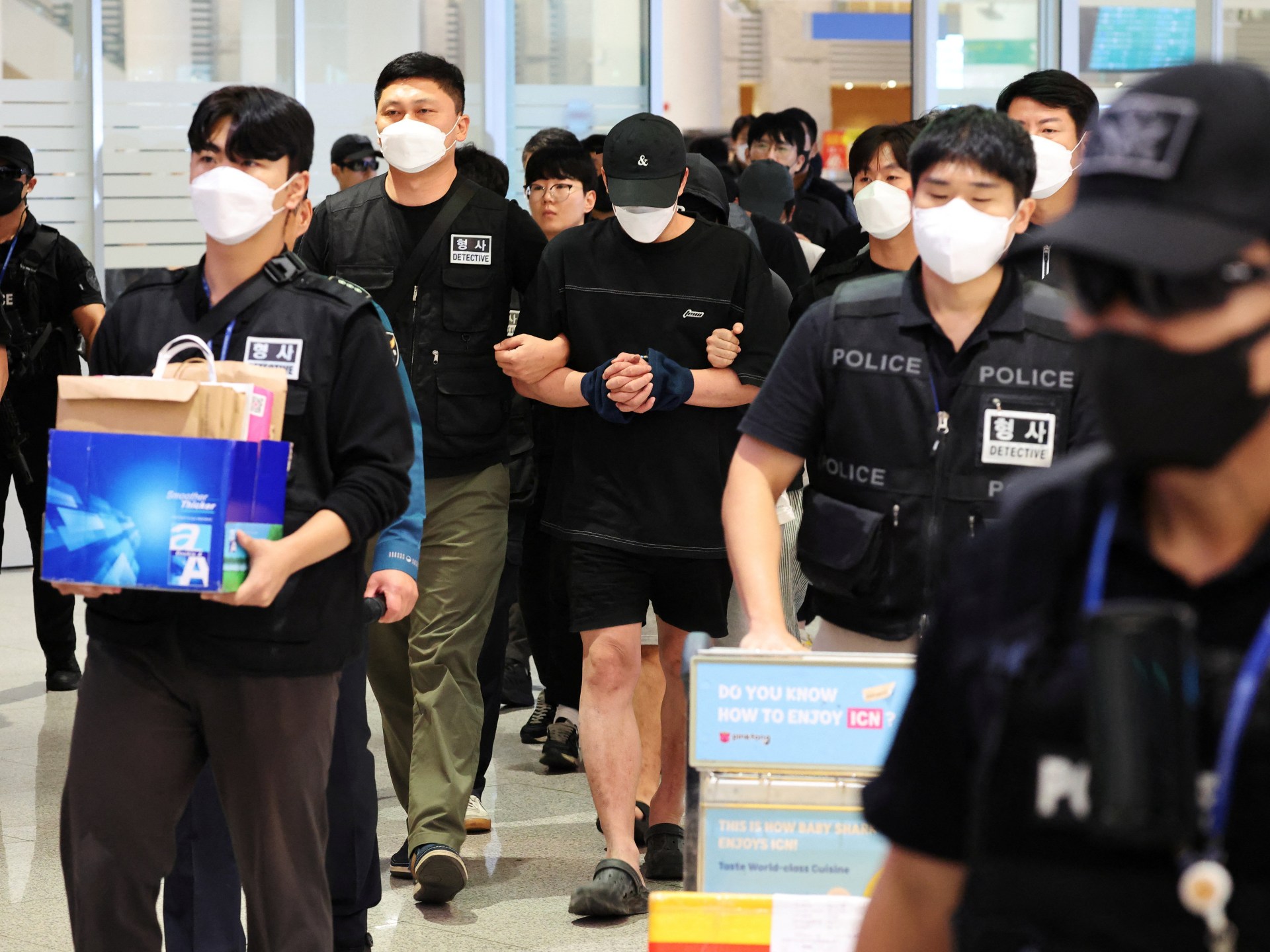 South Koreans freed from Cambodian scam centres return home under arrest