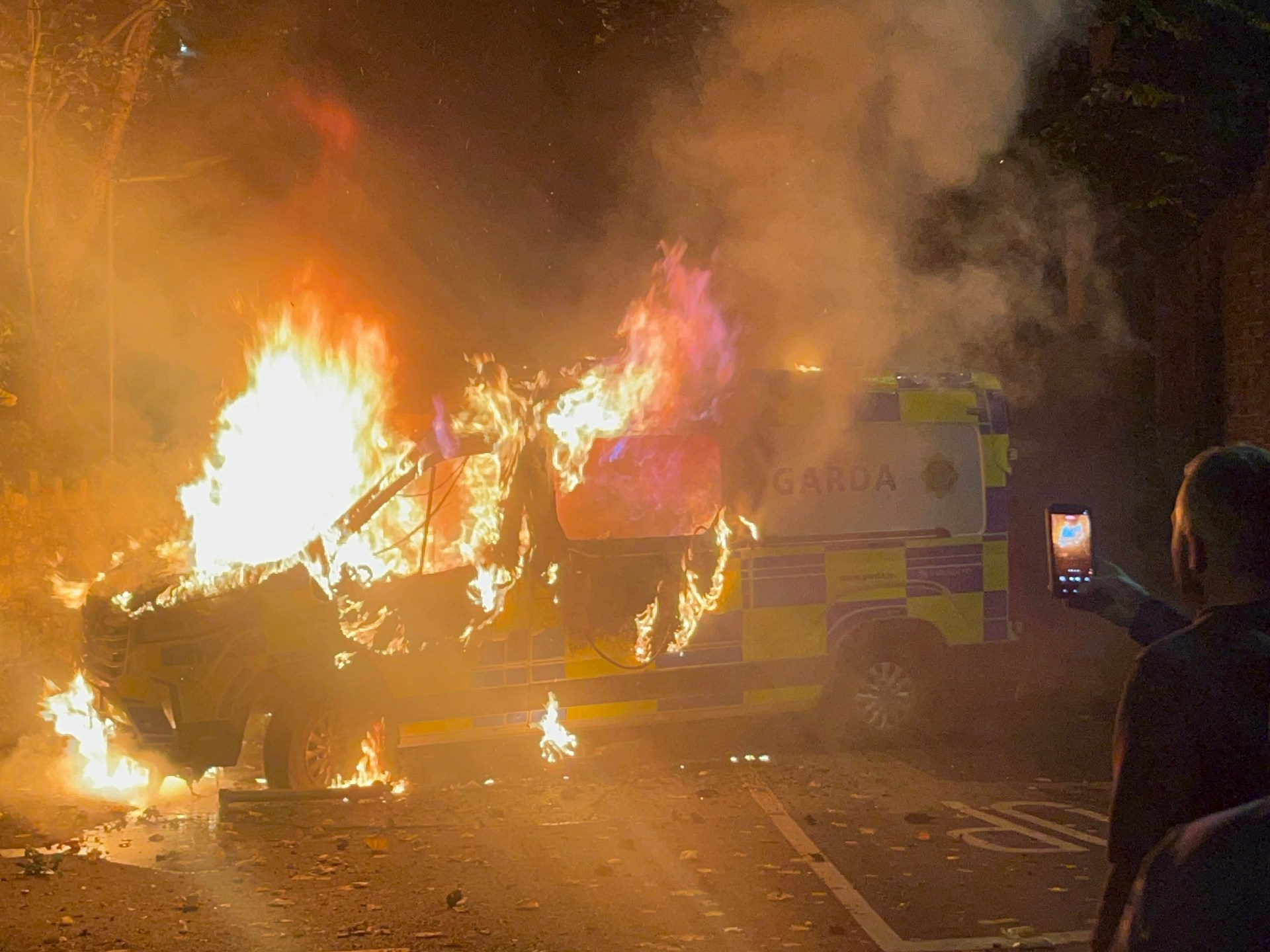 Hundreds of anti-immigrant protesters burn vehicle, attack police in Dublin