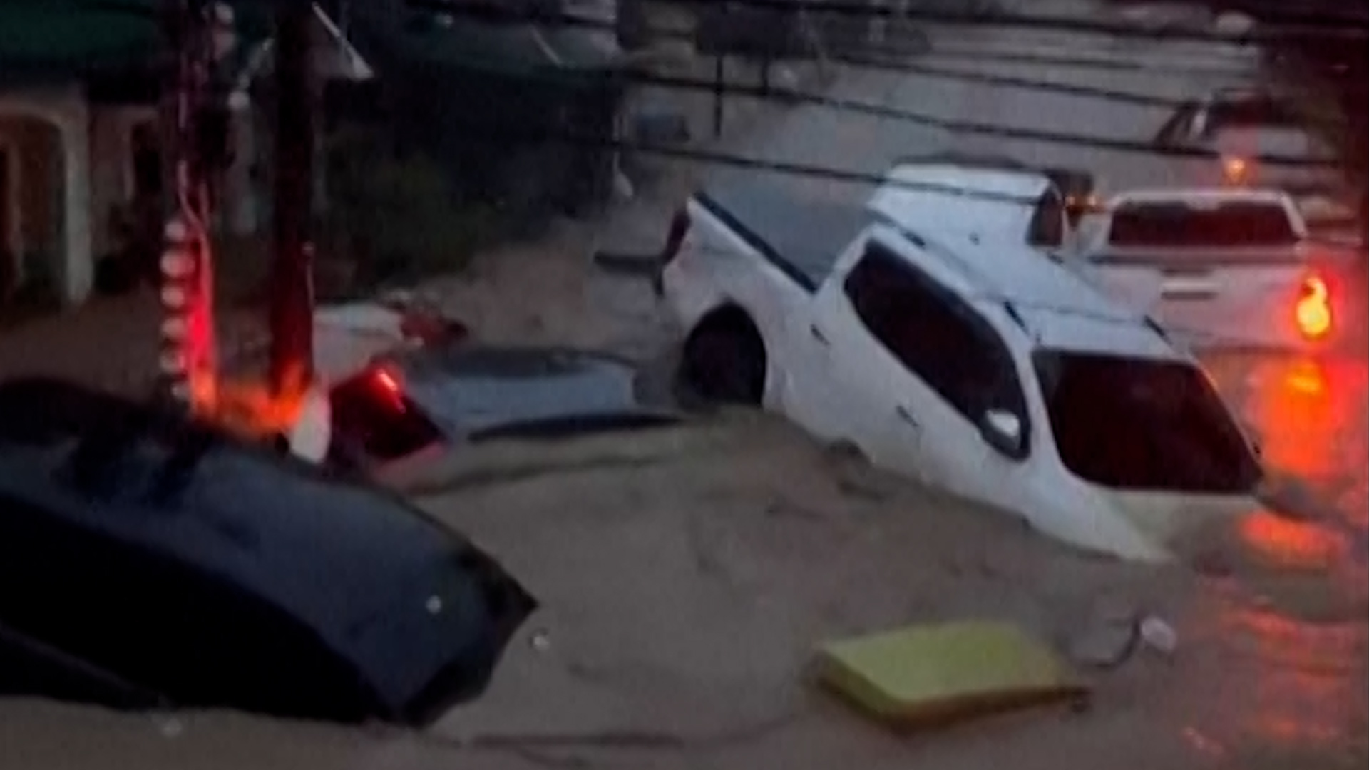 Video: Typhoon floods wash away cars and shipping containers in Philippines