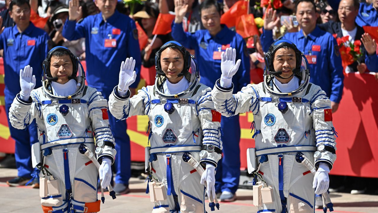 Three Chinese astronauts stranded in space after debris hits their return capsule