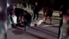 Moment officers wrangle 600lb alligator from Florida road
