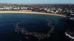 Surfers and swimmers pay tribute to victims of Bondi shooting
