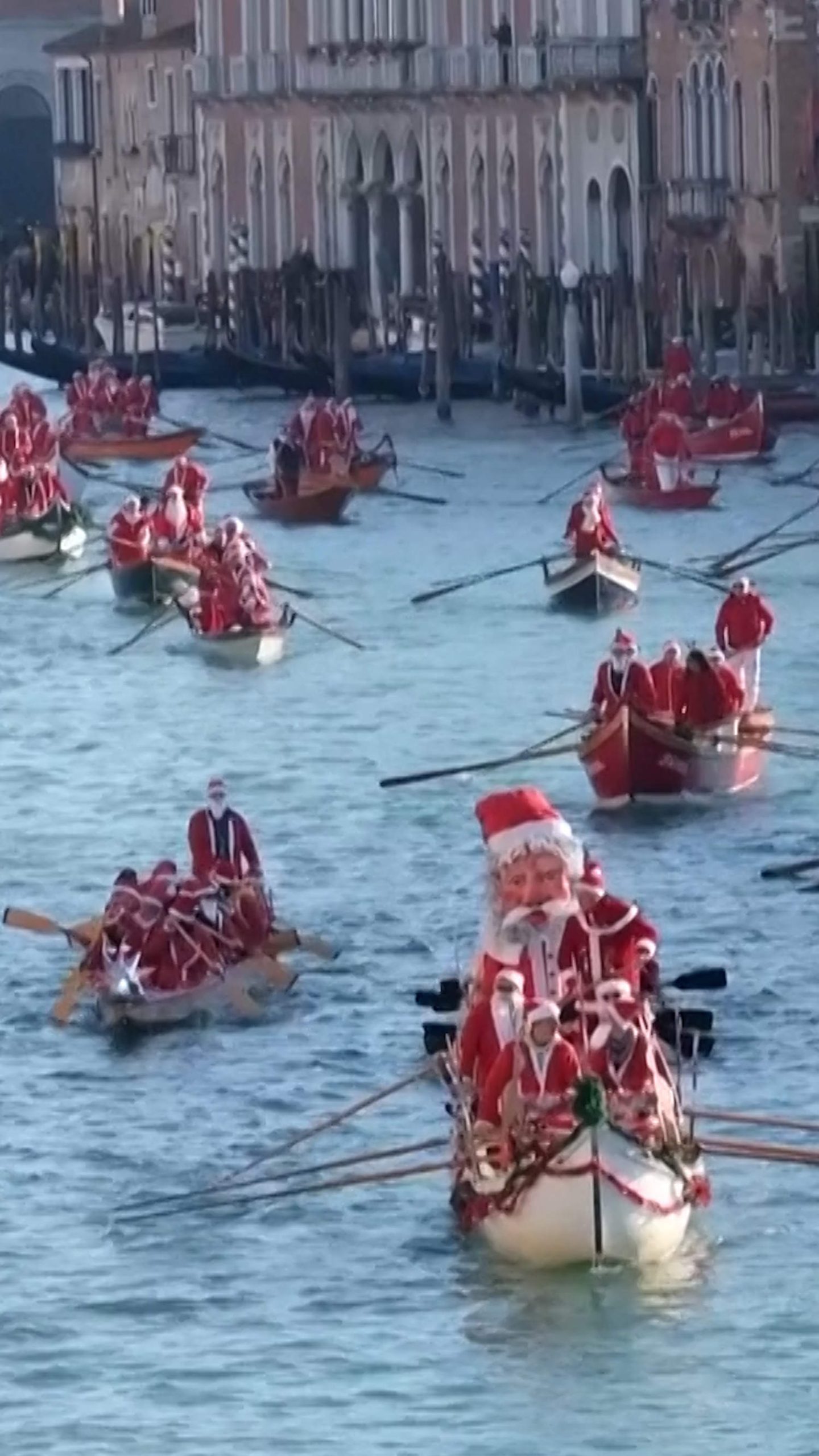 Santas sail the Grand Canal in Venice