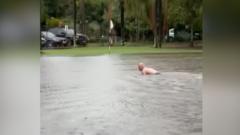 Man swims in flooded Sydney golf course after heavy rain