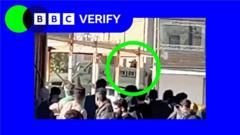 Iran security official appears to fire on crowd at cemetery