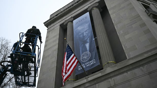 Banner with Trump’s image displayed outside Justice Dept. headquarters