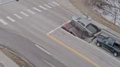 Watch: Moment a sinkhole in Omaha traps cars and drivers