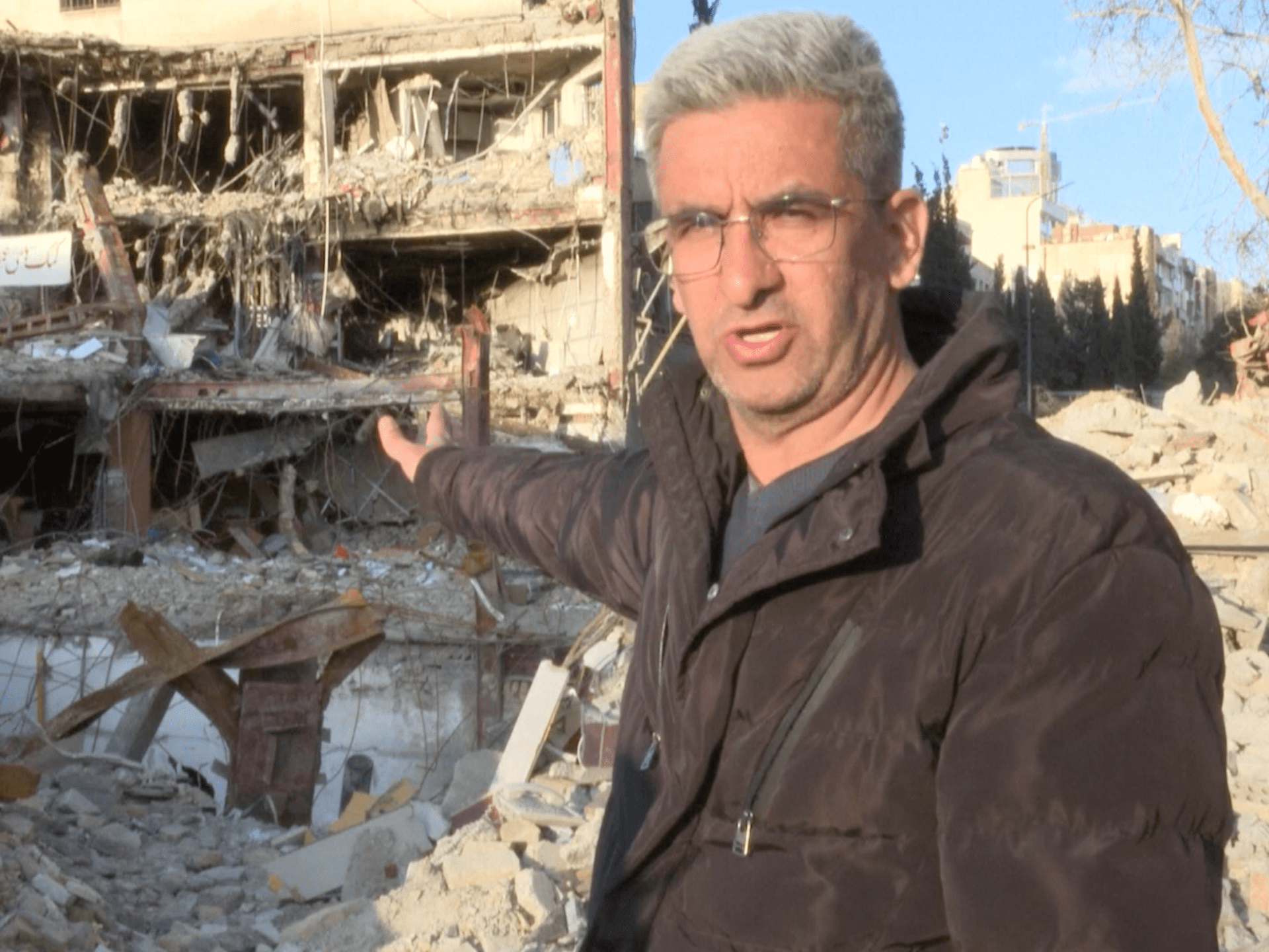 Brothers search rubble for missing sibling under Tehran rubble after strike