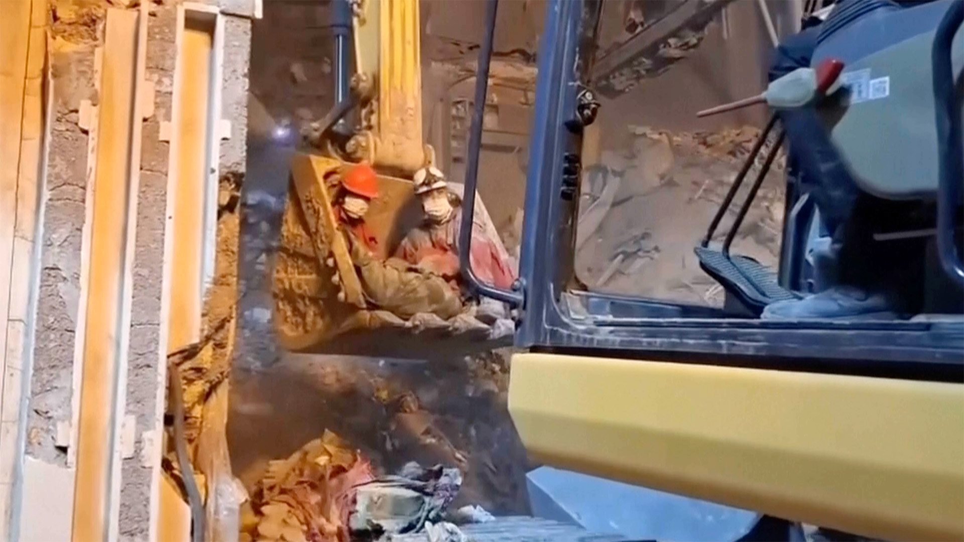 Rescuers search for survivors after strikes hit homes in Iran