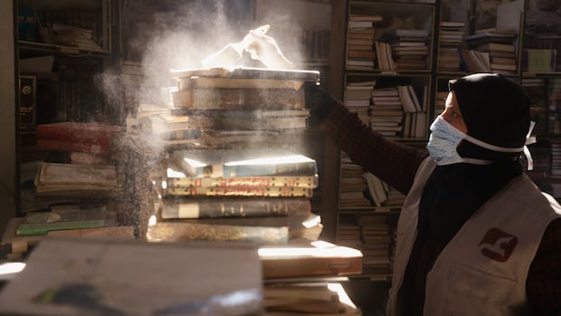 Armed with paintbrushes, volunteers try to preserve rare books at Gaza City’s Omari library