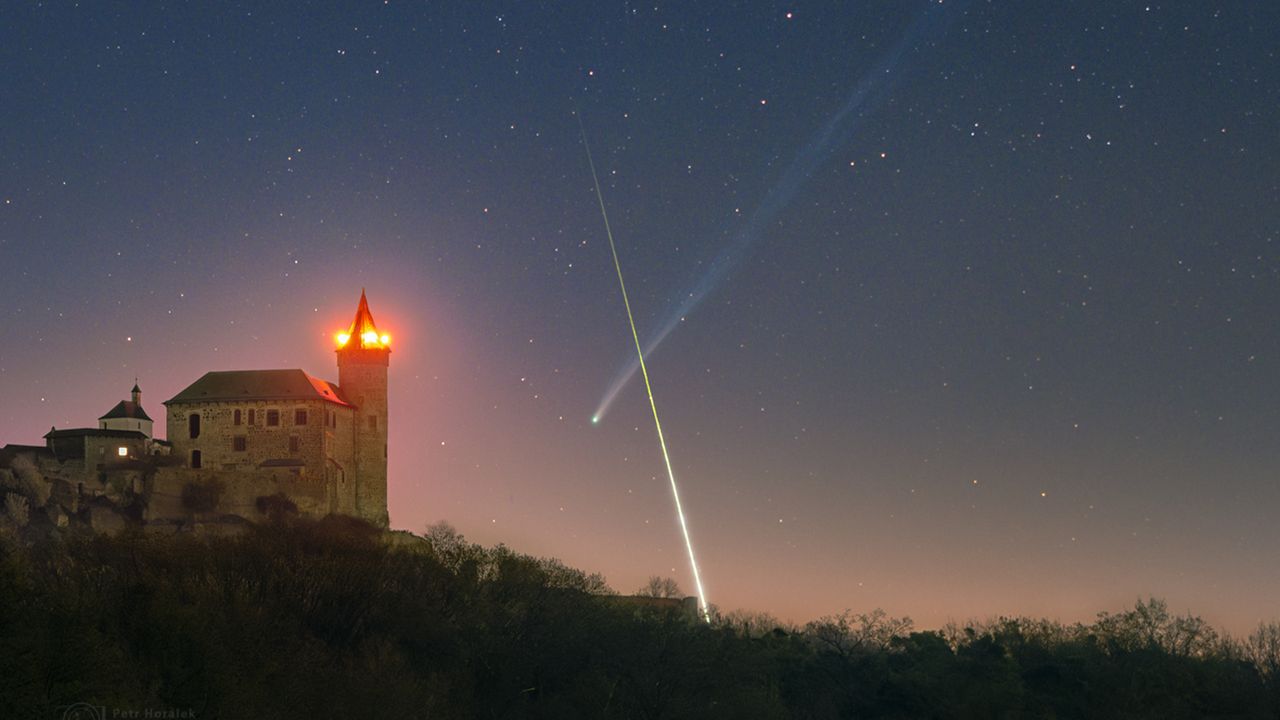 ‘What are the odds’: Superbright comet and exploding fireball meteor form near-perfect X over European castle