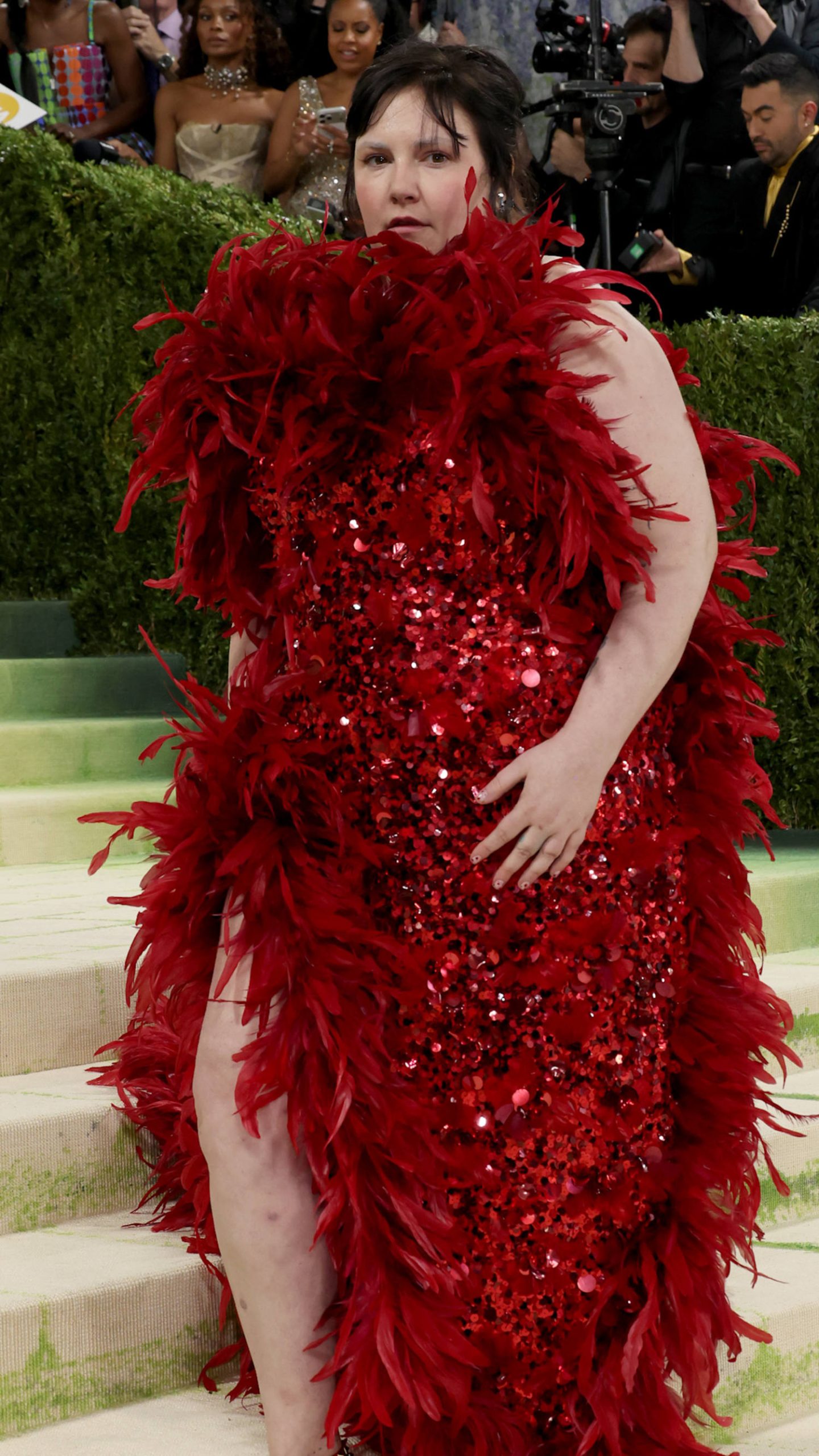 Lena Dunham takes flight in red feathered dress