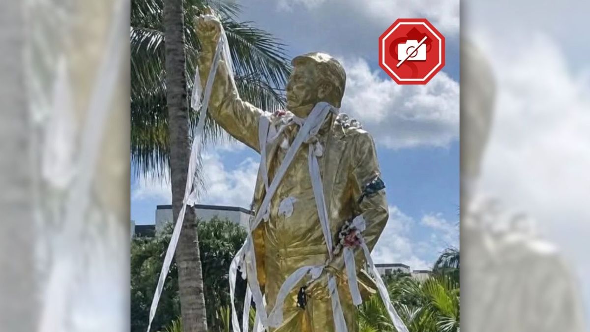 Was golden Trump statue vandalized with garbage, as shown in image?