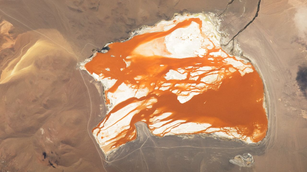 Rusty, orange water ‘bleeds’ across brilliant Bolivian lagoon — Earth from space