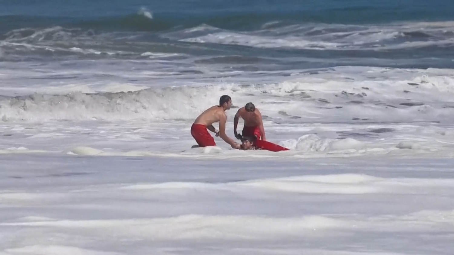 Dramatic video shows a 10-year-old boy rescued from pounding waves