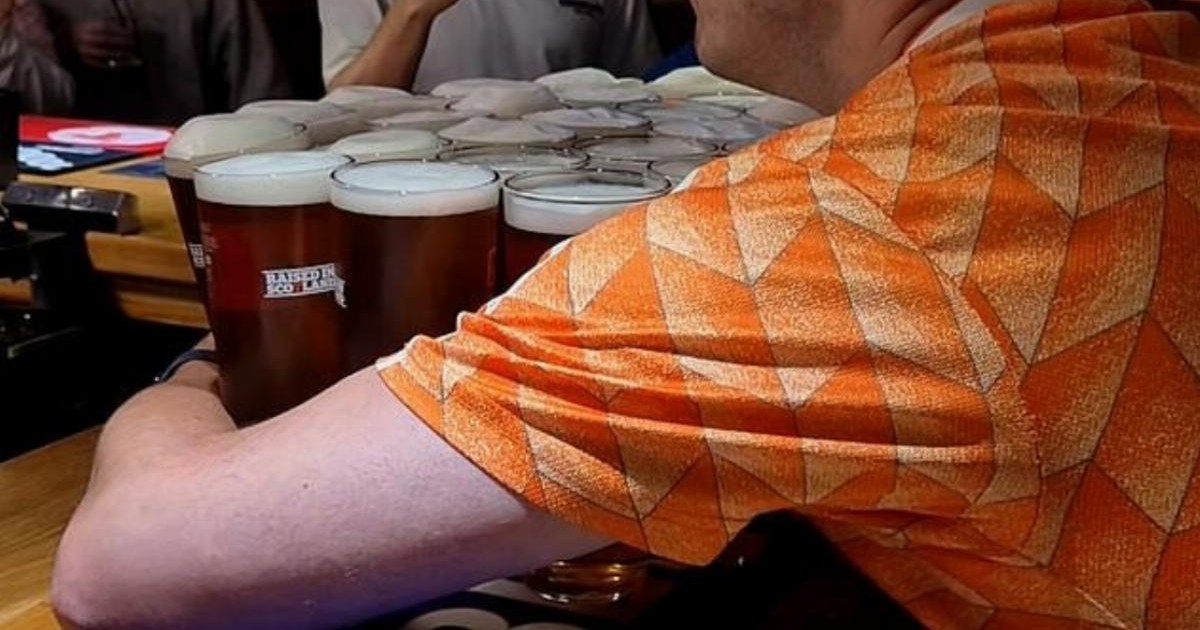 Dutch fan epically carries 26 pints of beer from the bar to his table – in one go