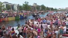 Crowds line Amsterdam’s canals for Pride boat parade