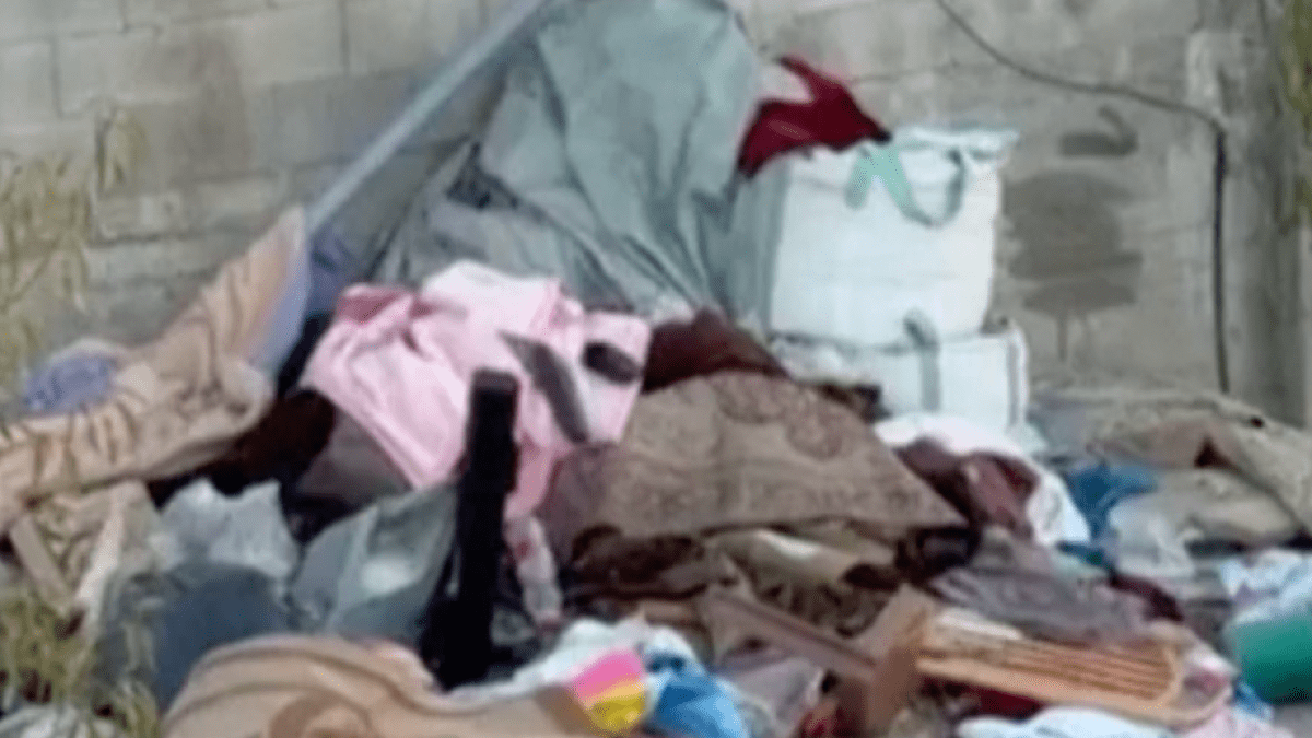Israeli soldiers throw belongings from besieged Palestinian home