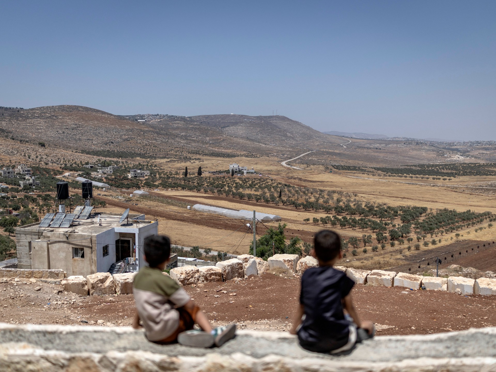 Two Palestinians killed as settlers, Israeli forces raid West Bank village