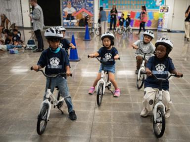 A childhood rite moves indoors as kindergartners learn to ride bikes in school gyms
