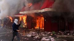 Violent clashes, looting and buildings ablaze in France as more than 1,200 arrested after protests